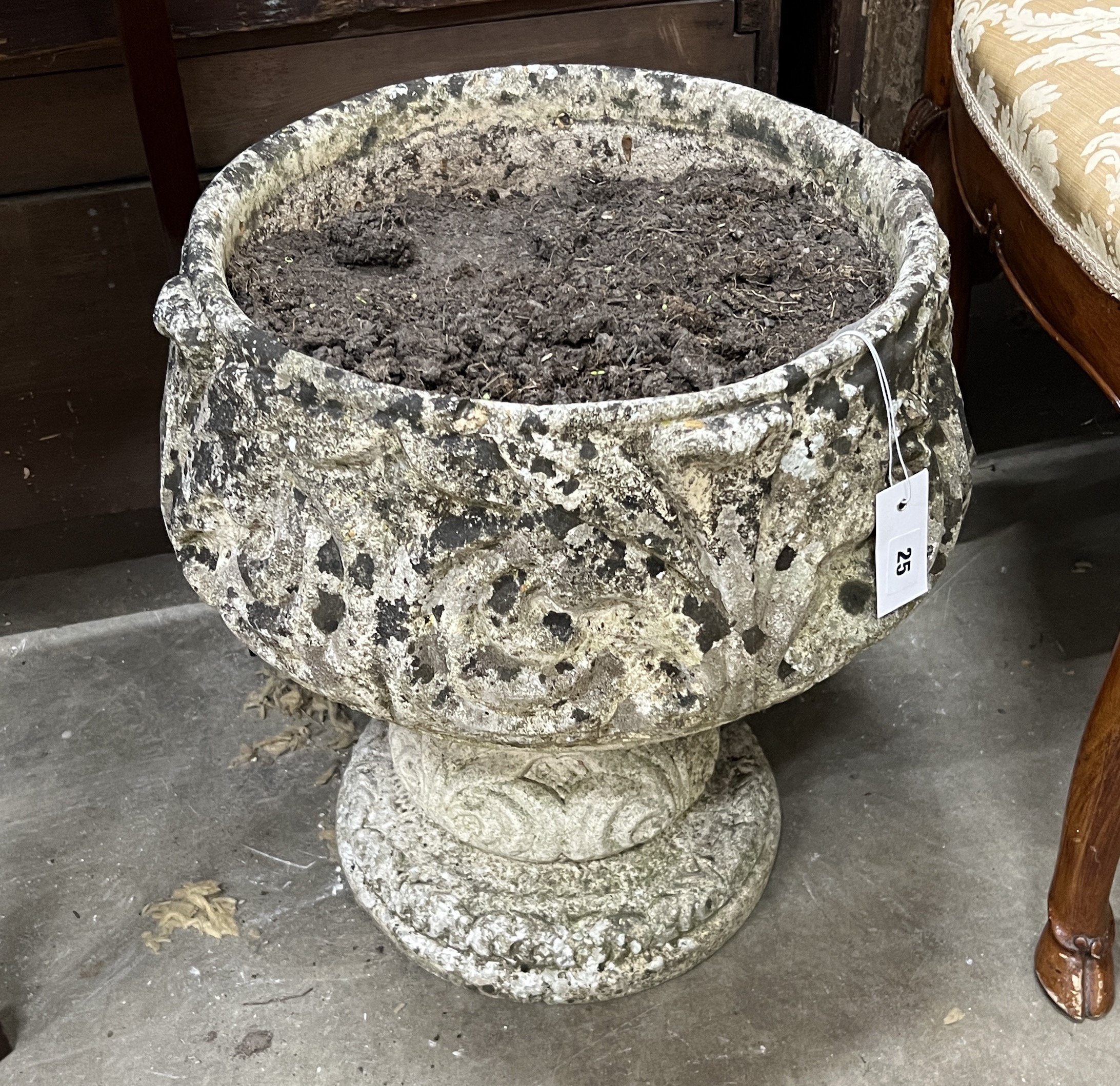 A circular reconstituted stone garden planter, diameter 42cm, height 46cm